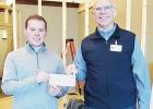 PRESENTS CHECK -- City Manager Thatcher Moddie (left) presented Harold Courtois, Memorial Health System CEO with a $5,000 check to help with the launch of Heartland Care Clinic, at 18 N Broadway, Herington. (Courtesy Photo) PRESENTS CHECK