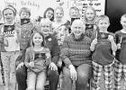 PRESENT KANSAS FLAGS -- Council Oak Chapter DAR members Patricia Schneider and Colleen Anderson are pictured with White City Elementary School second graders after they presented them with Kansas flags in honor of Kansas Day on Monday. The DAR chapter als PRESENT KANSAS FLAGS