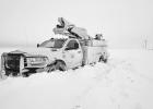 WORK TO RESTORE POWER -- Flint Hills Rural Electric Cooperative workers restored service to their area after Monday night’s storm but found the progress slow due to the snow depth and drifts, as evidenced in the photo. WORK TO RESTORE POWER