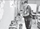 Students Remington Young, left and Maddox McClellan are pictured organizing some of the donated items.