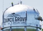WORKING UP HIGH -- Employees from Viking Industrial Painting are finishing up a 6-week refurbishing of the Council Grove water tower. Even with safety equipment, it takes a special person to work at heights, in the elements and away from one’s family. ( Viking Industrial Painting . . . A Look at Water Tower Restoration