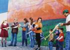 RIBBON CUTTING -- Erichsen Agri-Motive and the Council Grove Community Arts Council recently celebrated the city’s newest mural with a ribbon cutting. The mural, located on the side of Agri-Motive, is called “Tis a Gift to be Simple.” Pictured (L to RIBBON CUTTING