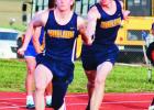 PERFECT HAND OFF -- Colton Elsen and Logan Stockwell execute the perfect hand off as the eighth grade boys 4x1 relay team wins first place at the Santa Fe Trail Junior High Track meet on Tuesday. Other team members are Cooper Andres and George Mascote. (P Article Image Alt Text