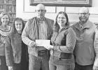PRESENT FINAL GIFTS -- Two locals on the far left of the photo, Debbie Miller and Julie Hower, and other members of the Symphony in the Flint Hills board members presented a final gift to the Tallgrass Legacy Alliance, one of four Flint Hills area non-pro PRESENT FINAL GIFTS -- Two locals on the far left of the photo, Debbie Miller and Julie Hower, and other members of the Symphony in the Flint Hills board members presented a final gift to the Tallgrass Legacy Alliance, one of four Flint Hills area non-pro