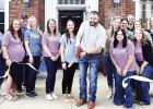 HOLD RIBBON CUTTING WITH NEW NAME