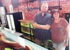 Frankie Greco and Maesha Pool paused from their work Monday, as they readied the Cut &amp; Chute Bar, which is scheduled to open Friday, May 29. at 200 W. Main in Council Grove.