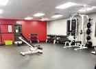 PREPARING FOR THE NEW WEIGHT ROOM -- Pictured left are some familiar guys helping move weight equipment into the newly expanded weight room at the Council Grove Life Center. With all the effort it took, only backsides are shown. From left to right - Zach PREPARING FOR THE NEW WEIGHT ROOM