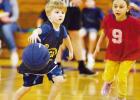 A LOOK OF DETERMINATION...Future Braves basketball star Thorin Sherwood, son of DJ and Alica Sherwood, dribbles down the court with determination Sunday during the CG City Recreation Department kindergarten basketball scrimmage. Thorin is being defended b Through Your Eyes